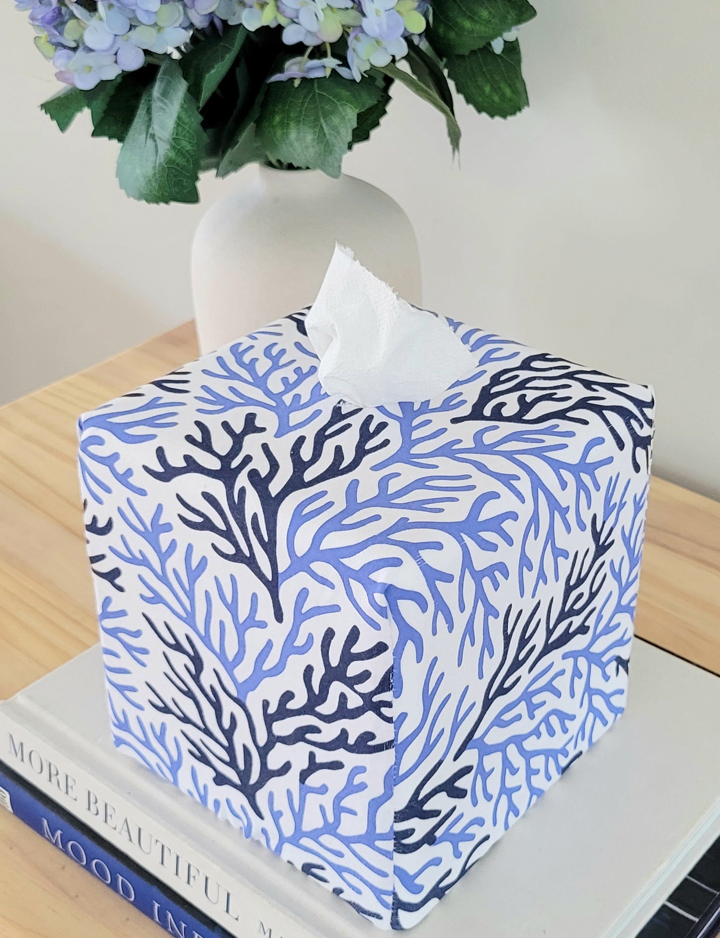 Cape Cod Coral AchooBox on a table with books and hydrangeas.