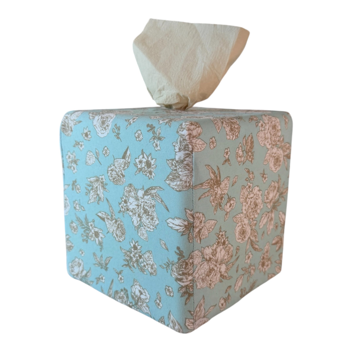 A tissue box that dispenses toilet paper instead of facial tissues. Tissue coming out of the designer dispenser in Surf Spray Garden Toile AchooBox 