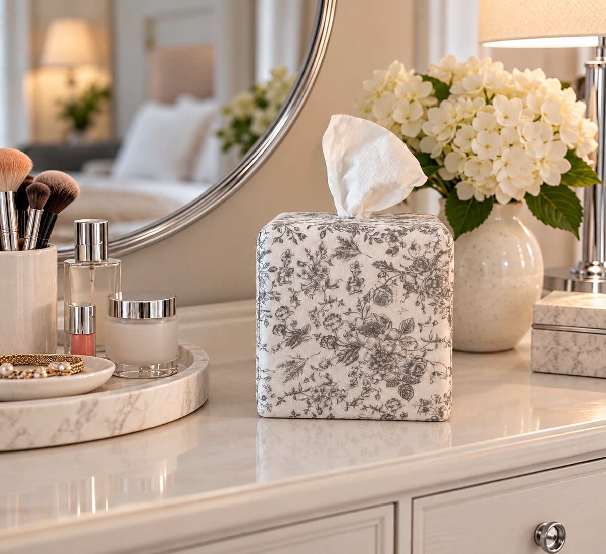 Parisian Slate Heirloom Toile AchooBox Rolled tissue dispenser on a vanity with chrome fixtures. 