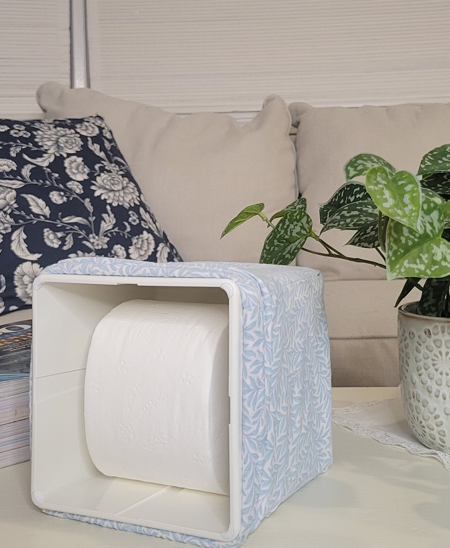 Soft Sky Leaf AchooBox showing the roll of tissue on a coffee table